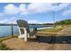 Relaxing lakeside view of Dockside Marina with Adirondack chair, inviting you to enjoy the waterfront at 5071 Woodmont Dr, Villa Rica, GA 30180