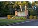 Welcoming entrance sign to Fairfield Plantation, adorned with vibrant flowers and lush landscaping at 5071 Woodmont Dr, Villa Rica, GA 30180