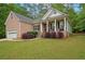 Lovely brick home with a cozy front porch and a spacious front lawn at 5071 Woodmont Dr, Villa Rica, GA 30180