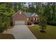 Charming brick home featuring a columned front porch and a well-manicured lawn at 5071 Woodmont Dr, Villa Rica, GA 30180