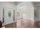 Elegant foyer with hardwood floors, decorative door, and formal dining area at 5071 Woodmont Dr, Villa Rica, GA 30180