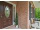 Close-up of a decorative front door, brick facade, and stylish shutters at 5071 Woodmont Dr, Villa Rica, GA 30180