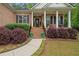 Charming front porch with brick columns, and nicely landscaped yard at 5071 Woodmont Dr, Villa Rica, GA 30180