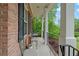 Inviting front porch with seating, columns, and brick facade at 5071 Woodmont Dr, Villa Rica, GA 30180