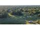 Aerial view of a lush golf course with mature trees and sand traps, offering a scenic recreational amenity at 5071 Woodmont Dr, Villa Rica, GA 30180