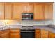 Well-equipped kitchen features granite countertops, stainless appliances and wooden cabinetry at 5071 Woodmont Dr, Villa Rica, GA 30180