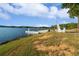 Scenic lake view with an Adirondack chair, offering a peaceful spot to relax and enjoy the water at 5071 Woodmont Dr, Villa Rica, GA 30180