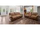 Open-concept living room features hardwood floors connecting kitchen, dining and living spaces at 5071 Woodmont Dr, Villa Rica, GA 30180