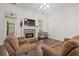 Cozy living room with a stone fireplace, comfortable seating, and a ceiling fan at 5071 Woodmont Dr, Villa Rica, GA 30180