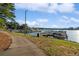 Picturesque view of the lake marina featuring boat slips and docks with a paved walkway along the shoreline at 5071 Woodmont Dr, Villa Rica, GA 30180