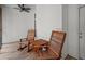 Cozy screened porch with ceiling fan and wooden rocking chairs at 5071 Woodmont Dr, Villa Rica, GA 30180
