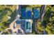 Aerial view of tennis courts and a swimming pool, showcasing the community's recreational facilities at 5071 Woodmont Dr, Villa Rica, GA 30180