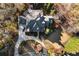 Aerial view of a home with a circular driveway, green roof, and meticulously maintained landscaping at 13230 Addison Rd, Roswell, GA 30075