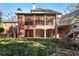 Expansive backyard featuring a covered porch and multi-level deck with stairs at 13230 Addison Rd, Roswell, GA 30075