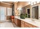 Bathroom features a double vanity with light wood cabinets and shutters on the window at 13230 Addison Rd, Roswell, GA 30075
