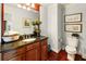 Well-lit bathroom featuring dark wood vanity, granite countertop, plants, and tile flooring at 13230 Addison Rd, Roswell, GA 30075