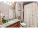 Well-lit bathroom with wood cabinets, granite countertop, and a shower/tub combination for a clean and functional design at 13230 Addison Rd, Roswell, GA 30075