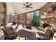 Covered patio with stone fireplace and ceiling fans for outdoor entertaining at 13230 Addison Rd, Roswell, GA 30075
