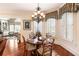 Cozy dining area featuring a chandelier, shuttered windows, and classic wood table and chairs at 13230 Addison Rd, Roswell, GA 30075