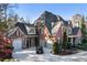 Beautiful brick home with a three-car garage and well-manicured landscaping at 13230 Addison Rd, Roswell, GA 30075