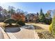 Stately brick home with lush landscaping, a circular driveway, and mature trees at 13230 Addison Rd, Roswell, GA 30075