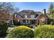 Elegant brick home with manicured landscaping and a charming front porch at 13230 Addison Rd, Roswell, GA 30075