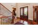 Welcoming foyer features hardwood flooring and an elegant staircase with iron railings at 13230 Addison Rd, Roswell, GA 30075