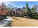 Impressive brick home with mature landscaping and a circular driveway at 13230 Addison Rd, Roswell, GA 30075