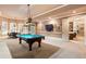 Entertaining game room with a pool table, bar, and adjacent seating area with shutters at 13230 Addison Rd, Roswell, GA 30075