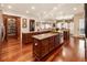 Open kitchen design featuring dual islands, granite countertops, custom cabinets and hardwood floors at 13230 Addison Rd, Roswell, GA 30075