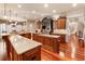 Large kitchen with dual islands, granite countertops, custom cabinets, hardwood floors, and eating area at 13230 Addison Rd, Roswell, GA 30075