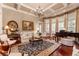 Warm living room boasting coffered ceilings, hardwood floors, a piano, and stylish furnishings at 13230 Addison Rd, Roswell, GA 30075