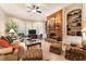 Cozy living room with brick fireplace, built-in bookshelves, and comfortable seating area at 13230 Addison Rd, Roswell, GA 30075