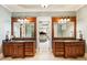 Dual vanities in main bath with mirrors, offering plenty of space and style at 13230 Addison Rd, Roswell, GA 30075
