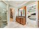 Main bathroom with glass shower, vanity, and dressing area, offering privacy and luxury at 13230 Addison Rd, Roswell, GA 30075