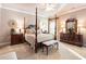 Main bedroom boasting dark wood furniture, soft carpeting, and a serene ambiance for restful nights at 13230 Addison Rd, Roswell, GA 30075