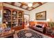 Cozy home office with wood-paneled walls, built-in bookshelves, and coffered ceilings at 13230 Addison Rd, Roswell, GA 30075