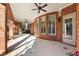 Covered patio with brick columns, ceiling fans, and outdoor seating area at 13230 Addison Rd, Roswell, GA 30075
