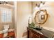 Elegant powder room with custom mirror and vanity, exuding sophisticated charm at 13230 Addison Rd, Roswell, GA 30075