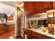 Wet bar area with granite countertop and wine glass rack at 13230 Addison Rd, Roswell, GA 30075