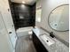 A modern bathroom featuring a dark tiled wall and a granite countertop vanity at 1341 E Atlanta E Rd, Stockbridge, GA 30281