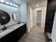 Bathroom featuring granite countertop, dual sinks, tile shower, and spacious walk-in closet at 1341 E Atlanta E Rd, Stockbridge, GA 30281