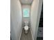 Bathroom includes a toilet, a window, and a shower with gray flooring at 1341 E Atlanta E Rd, Stockbridge, GA 30281