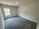 A well-lit bedroom featuring neutral walls, plush carpeting, and a window offering natural light at 1341 E Atlanta E Rd, Stockbridge, GA 30281