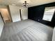 Bedroom with dark accent wall, gray carpet and modern ceiling light at 1341 E Atlanta E Rd, Stockbridge, GA 30281
