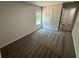 Bedroom with gray walls and carpet, window, and a white door at 1341 E Atlanta E Rd, Stockbridge, GA 30281
