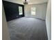 Spacious bedroom featuring statement wall, modern light fixture, and large windows offering natural light at 1341 E Atlanta E Rd, Stockbridge, GA 30281