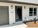 Exterior view of a home with an attached garage, showcasing modern lighting fixtures and a 0% down payment sign at 1341 E Atlanta E Rd, Stockbridge, GA 30281