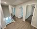 Upstairs hallway with luxury vinyl plank flooring leading to carpeted bedrooms and a staircase to the entry at 1341 E Atlanta E Rd, Stockbridge, GA 30281