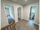 Upstairs hallway with luxury vinyl plank flooring leading to a bathroom and carpeted bedroom at 1341 E Atlanta E Rd, Stockbridge, GA 30281